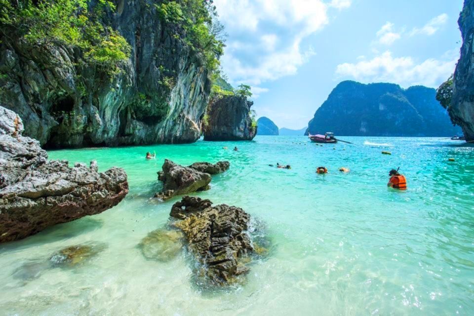 Snorkeling in turquoise water beneath Hong Island's limestone cliffs